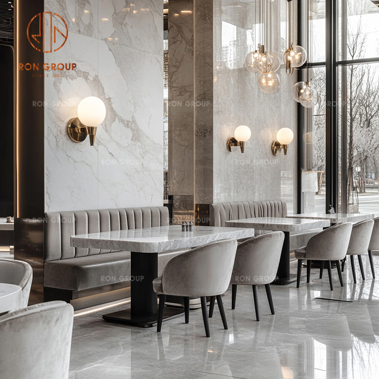 Modern Restaurant Booth Seating with Marble Tables and Grey Velvet Chairs