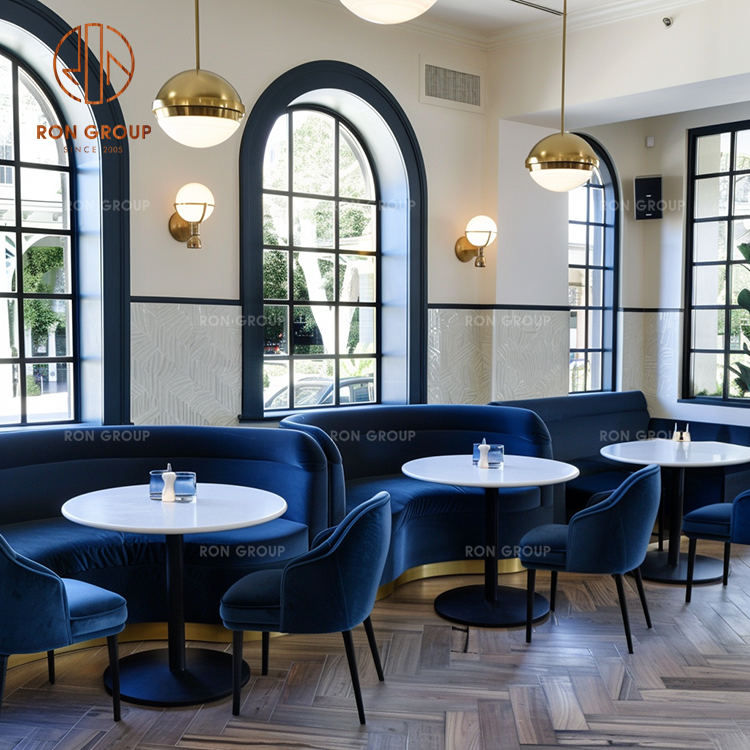 Blue Velvet Restaurant Booth Seating with White Marble Round Tables and Metal Dining Chairs