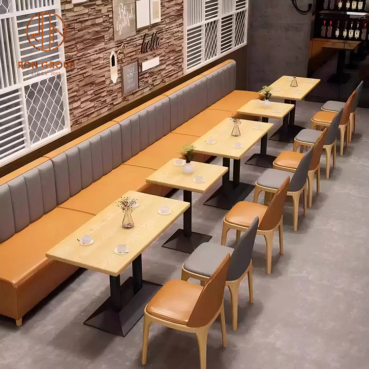 Modern Cafe Booth Seating with Orange Leather Chairs and Wood Square Tables